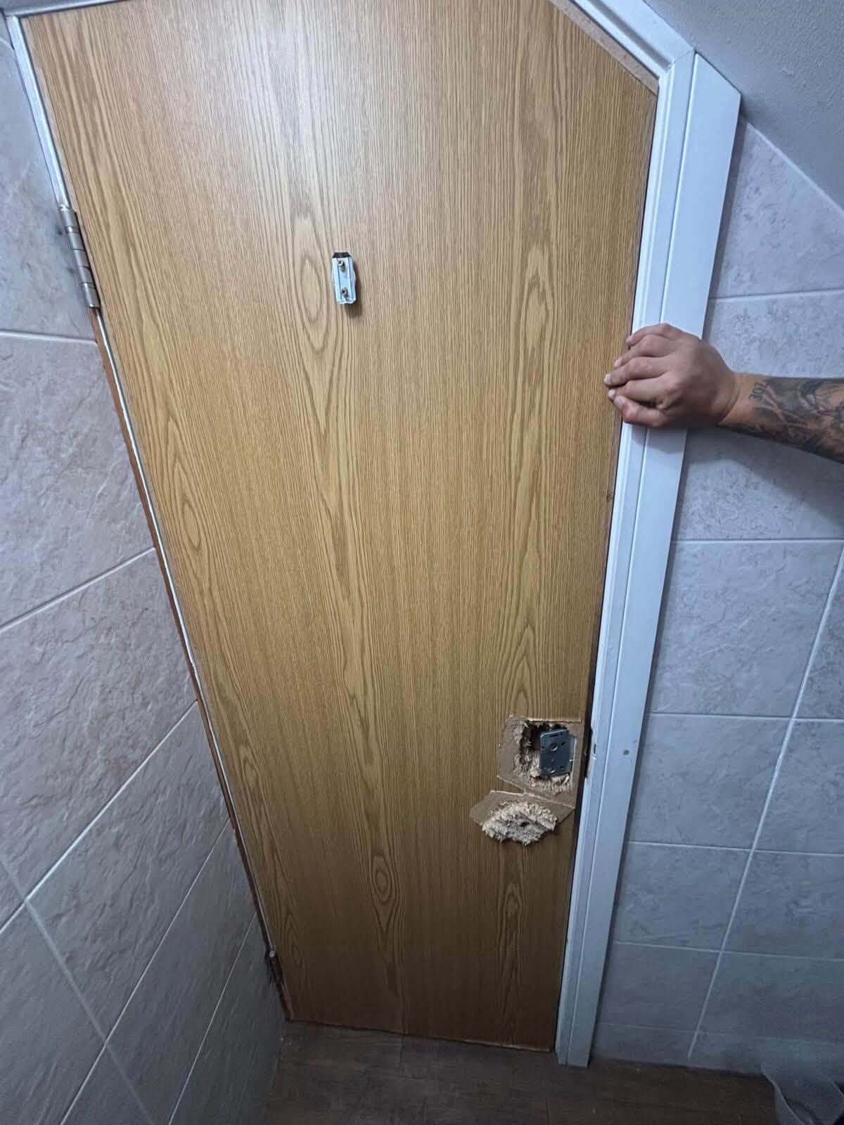 Commercial Bathroom Door With Severe Damage Around the Lock Area