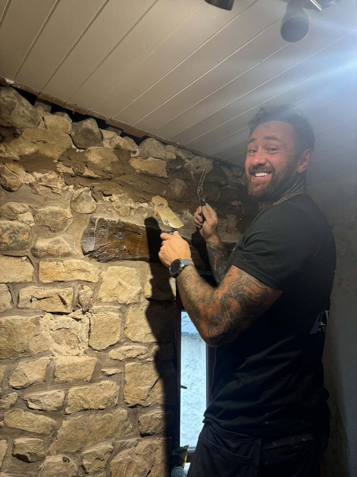 Original Stone Wall Being Restored During a Countryside Cottage Renovation